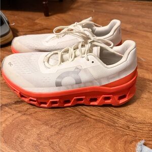 On Running Cream and Orange Athletic Shoes